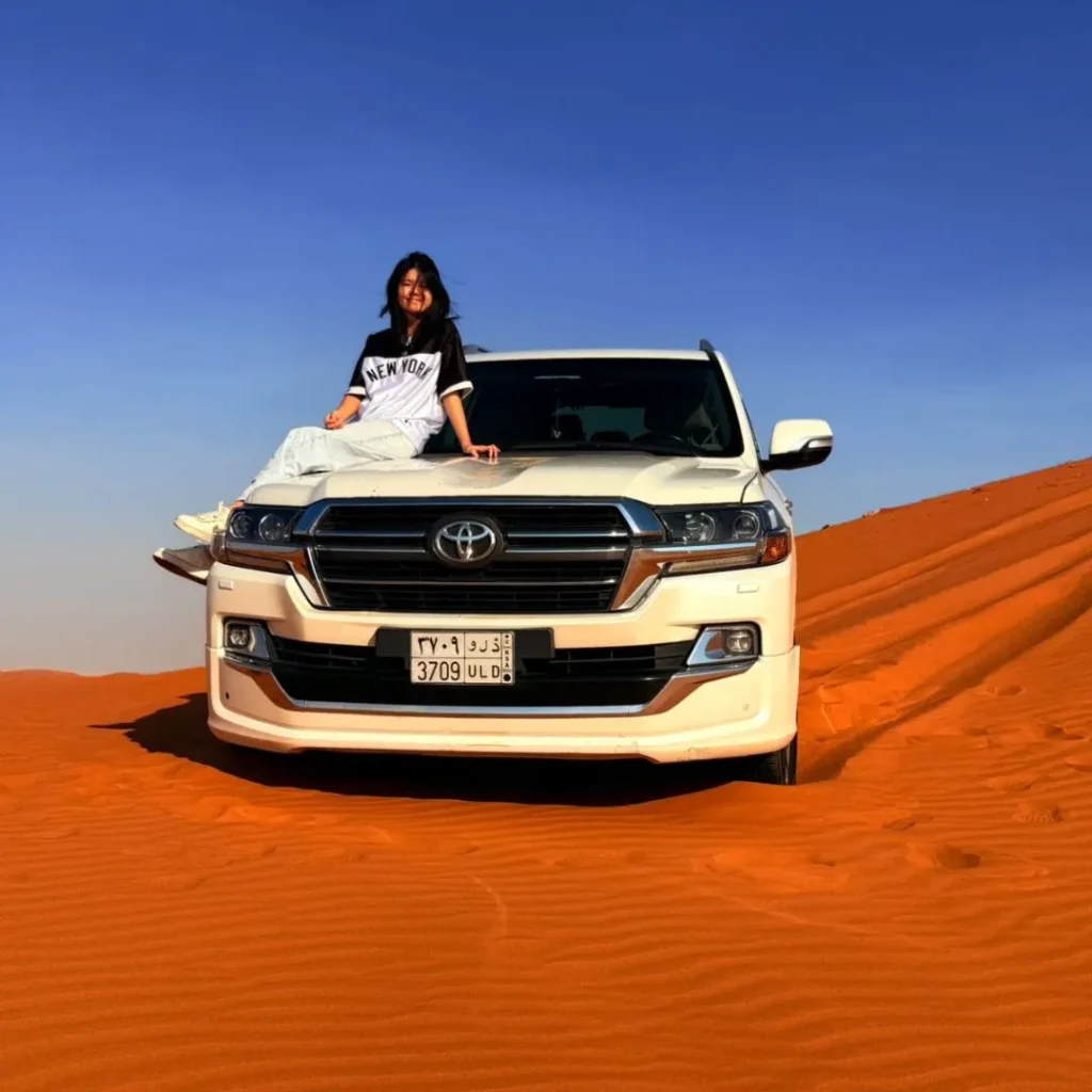 Riders exploring desert dunes during sunrise for Morning vs Evening Quad Biking Riyadh experience.