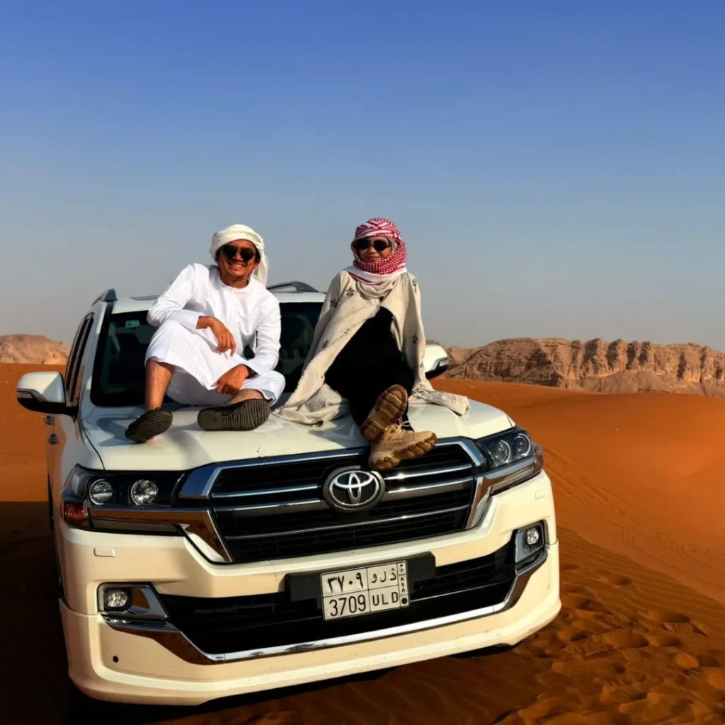 Family enjoying a Family-Friendly Desert Safari in Riyadh with kids riding camels and exploring sand dunes safely.