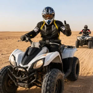 "Why Quad Biking in Riyadh Is a Must Try for Adventure Lovers – tourists riding quad bikes across golden desert dunes with natural sunlight"