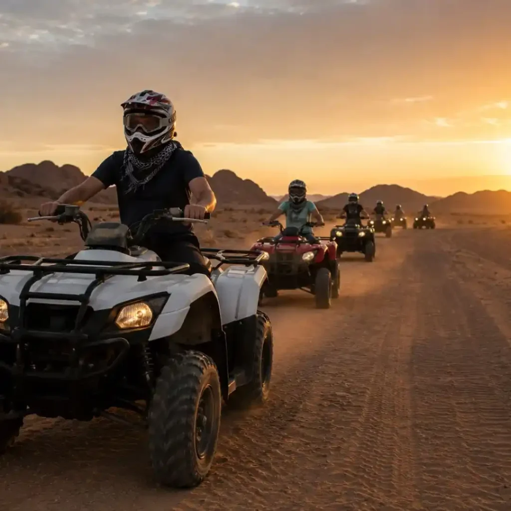 "You Need to Know Before Quad Biking Riyadh – tourists riding ATVs across golden desert dunes under natural sunlight and clear sky"