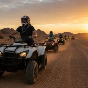 "You Need to Know Before Quad Biking Riyadh – tourists riding ATVs across golden desert dunes under natural sunlight and clear sky"